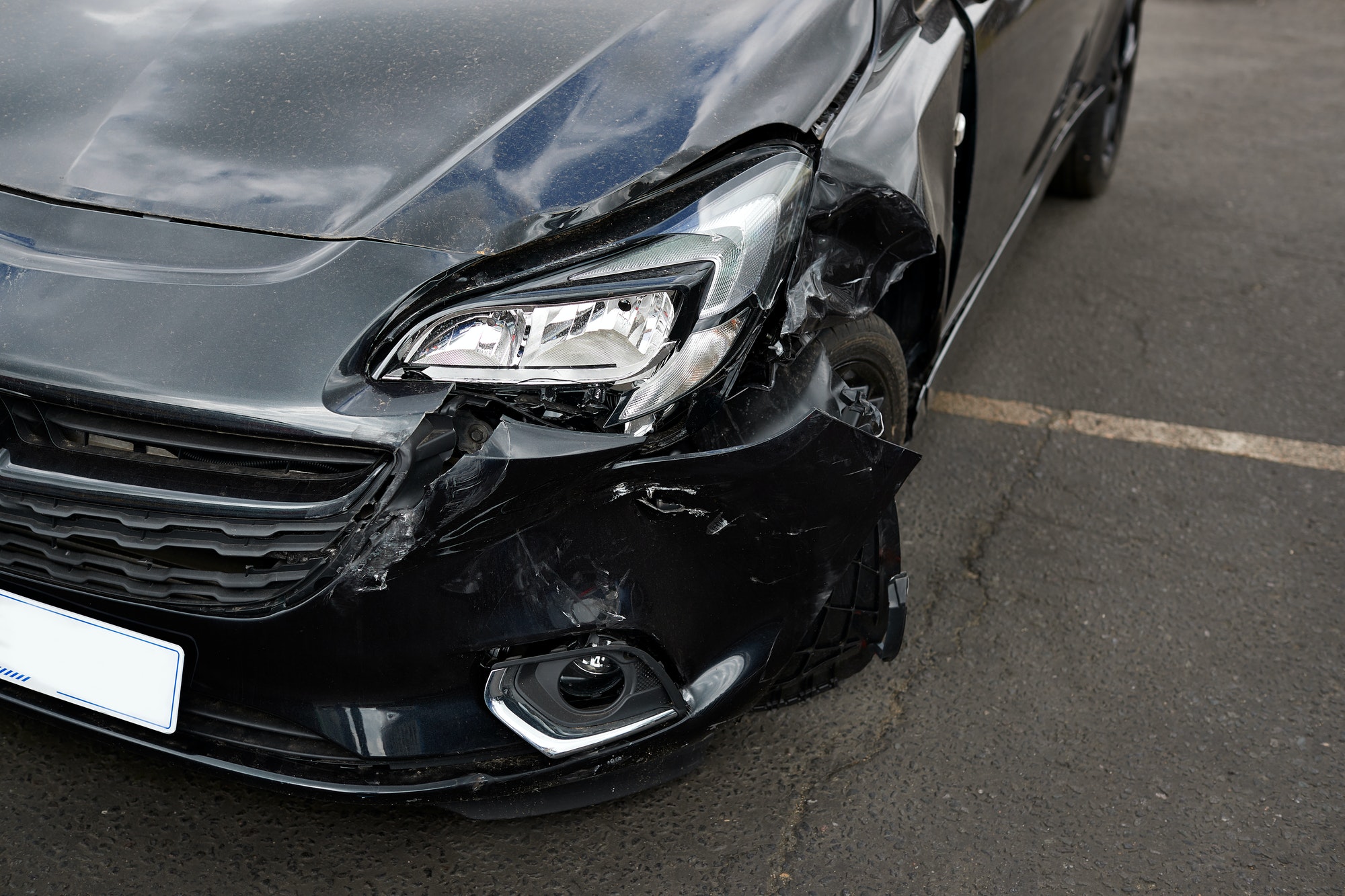 Detail Of Damage To Headlight Of Vehicle In Car Park